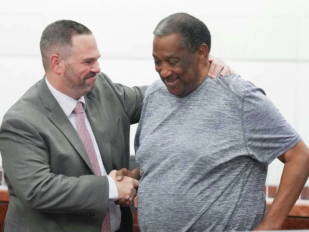 Justin Keiter shaking hands with client Frank Moaning in the courtroom after the verdict